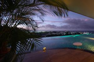 a view of a swimming pool from a house at Glamday Style Okinawa Yomitan Hotel & Resort in Yomitan