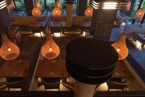 a view of a restaurant with tables and lights at Glamday Style Okinawa Yomitan Hotel & Resort in Yomitan