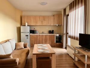 a living room with a couch and a table at Studio Paradise - Near Tsarevets&Central Location in Veliko Tŭrnovo