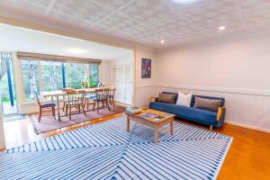a living room with a blue couch and a table at Havehus in Denmark