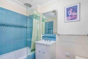 a bathroom with a tub and a sink and a shower at Havehus in Denmark +13 photos