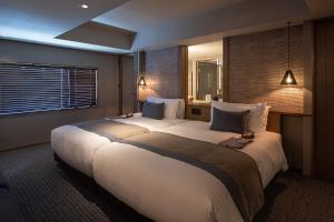 a hotel room with two large beds in it at Glamday Style Okinawa Yomitan Hotel & Resort in Yomitan