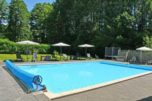 a large swimming pool with a blue water slide at Gutshaus_Appartements mit Kamin_ S in Coldevitz +72 photos