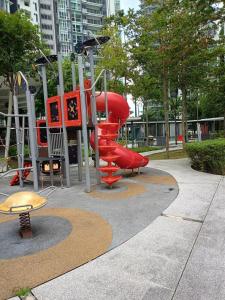 a playground with a red slide in a park at AGH-Medini Signature轻奢温馨风-3分钟乐高乐园-儿童游戏角落-儿童亲善-9pax in Nusajaya