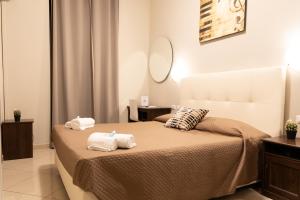 a bedroom with two towels on a bed at Golden Milano Hotel in Milan