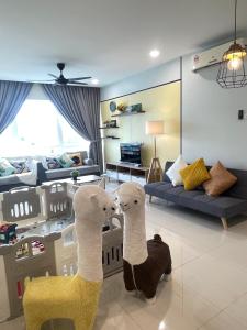 two stuffed animals are standing in a living room at AGH-Medini Signature轻奢温馨风-3分钟乐高乐园-儿童游戏角落-儿童亲善-9pax in Nusajaya