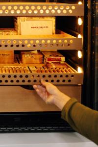 a person is reaching for a box of food in an oven at Paros Agnanti Resort & Spa in Parikia
