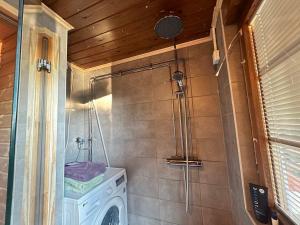 a small bathroom with a washing machine in it at Countryside riverside cabin for both winter and summer in Janakkala +44 photos