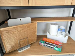 a wooden drawer with a cell phone and other items on it at ゆったり過ごすには最適 ビーチ近く 開放感あり Mountain villa okinawa in Motobu