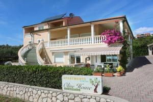 a large house with a sign in front of it at Olive House in Šimuni