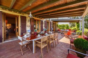 an outdoor patio with a table and chairs at Villa D'Agnola by Mmega in San Casciano in Val di Pesa