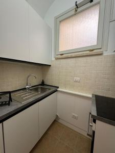 a kitchen with a sink and a window at Casa nel Vicolo - Duomo di Osimo e 20 min da Loreto in Osimo +7 photos