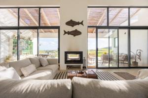 a living room with a couch and a fireplace at Casa Nook Sagres in Vila do Bispo