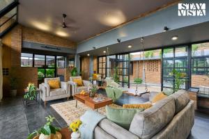 a large living room with couches and a table at StayVista at Rustic Haven with Pvt Pool, Gazebo & Indoor-Outdoor Game in Satara