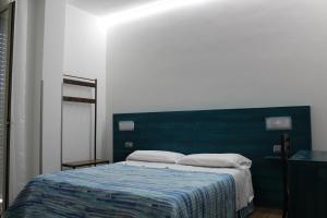 A bed or beds in a room at Otto&Mezzo B&B