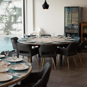 a dining room with a large table and chairs at Hotel Gran Sol De Extremadura in Montijo