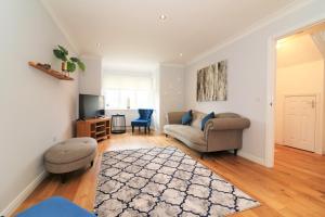 a living room with a couch and a tv at Signature - Morrison House in Glasgow