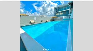 a swimming pool in front of a building at STARFISH LUXURY APARTMENT in San Juan
