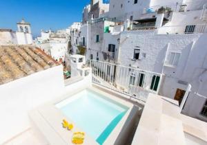 a swimming pool on the roof of a building at Italianway - Casa Leo in Ostuni