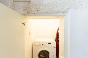 a washer and dryer in a small bathroom at Italianway - Casa Leo in Ostuni +1 photo