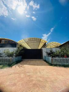 a building with a fence in front of it at Guest house Amirhan in Bokonbayevo