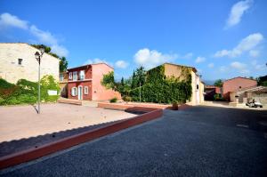 an empty street in a town with two buildings at Villa Les Mimosas, Fayence in Fayence