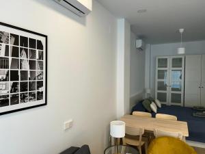 a room with a bed and a table and chairs at AZCA-Bernabéu Apartments in Madrid
