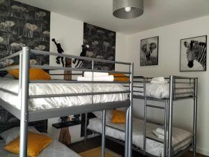 a room with three bunk beds in a room at Le Bois de Luché in Rom