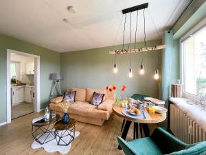 a living room with a couch and a table at LIGHTQUARTIER Mountain Nest -Balkon in Sankt Andreasberg