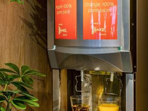 a coffee machine with two glasses of wine at ibis Bordeaux Centre - Gare Saint-Jean in Bordeaux
