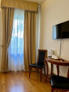TV a/nebo společenská místnost v ubytování Locanda del Ghetto