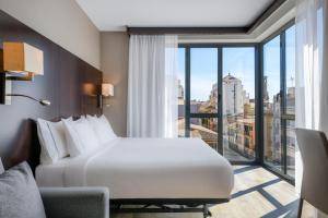 a hotel room with a bed and a large window at AC Hotel Ciutat de Palma by Marriott in Palma de Mallorca