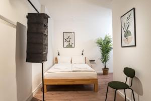 un dormitorio con una cama y una silla en Spacious 1-Bedroom Apartment in Kreuzberg, en Berlín