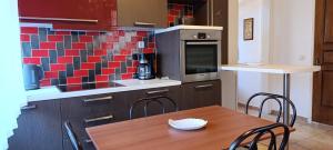 a kitchen with a wooden table with chairs and a counter at Traditional two level Apartment in Liapades