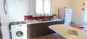 a kitchen with a refrigerator and a washing machine at Traditional two level Apartment in Liapades +19 photos