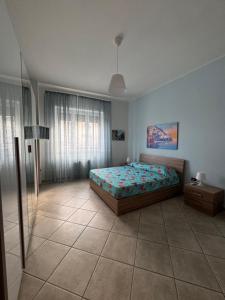 a bedroom with a bed and a lamp in it at Casa di Giulia un angolo della costiera Amalfitana in Salerno