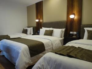 Postel nebo postele na pokoji v ubytování Siena Hotel