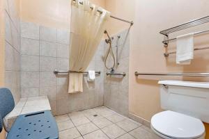 a bathroom with a toilet and a shower at Quality Inn Amarillo West near Medical Center in Amarillo