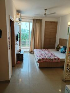 a bedroom with a large bed and a balcony at Hari Priya house The Divine Homestay in Vrindāvan