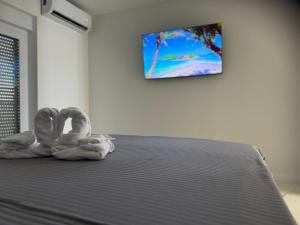 two towel animals sitting on top of a bed at Apartmani Emanuel in Nin