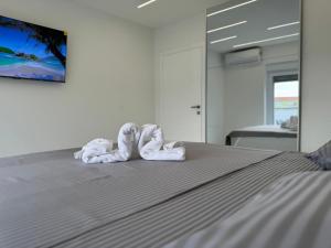 a bed with two towels in the shape of hearts at Apartmani Emanuel in Nin +24 photos