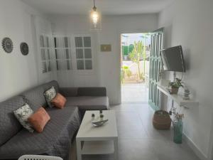 a living room with a couch and a table at Cotillo in El Cotillo