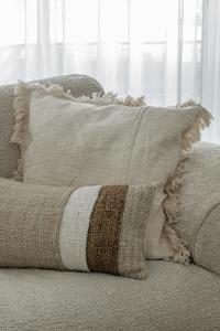 a pillow sitting on top of a couch at Enso District Residences in Knokke-Heist