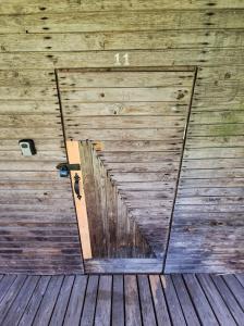 a wooden wall with a door in a barn at Fish and sleep - lake house in Alūksne +9 photos