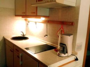 a kitchen counter with a coffee maker and a sink at Apartma Vitez in Izola