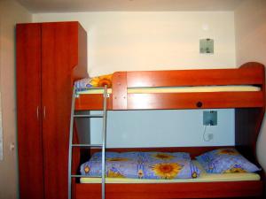 a bedroom with two bunk beds and a bunk bed at Apartma Vitez in Izola