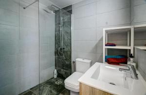 a bathroom with a shower and a toilet and a sink at Buena Vista in Los Cristianos +6 photos