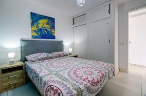 a bedroom with a bed and a painting on the wall at Buena Vista in Los Cristianos