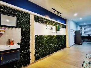a green wall in a bathroom with a sink at 11pax5br Modern 5mins Ipoh Town wPoolTable in Ipoh +21 photos