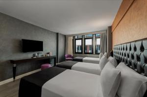 a hotel room with two beds and a television at Istanbul Golden City Hotel in Istanbul